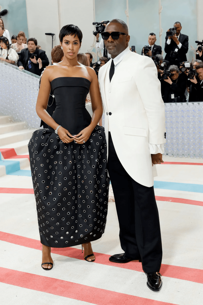 Idris Elba wore a chic white tailcoat with black slacks, and his wife Sabrina wore a black strapless dress with a structured skirt covered in white dots.