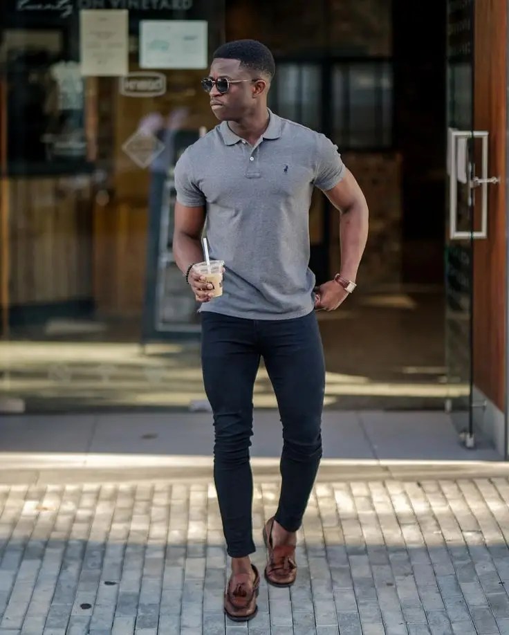 A man wearing a polo shirt and pants