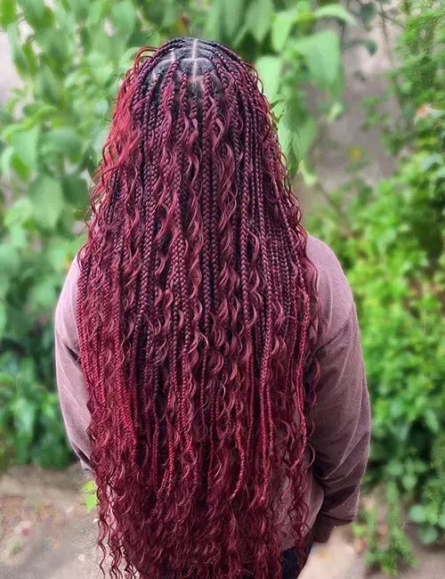 Lady rocks little knotless braids and pulls extensions out of each braid to create curls.