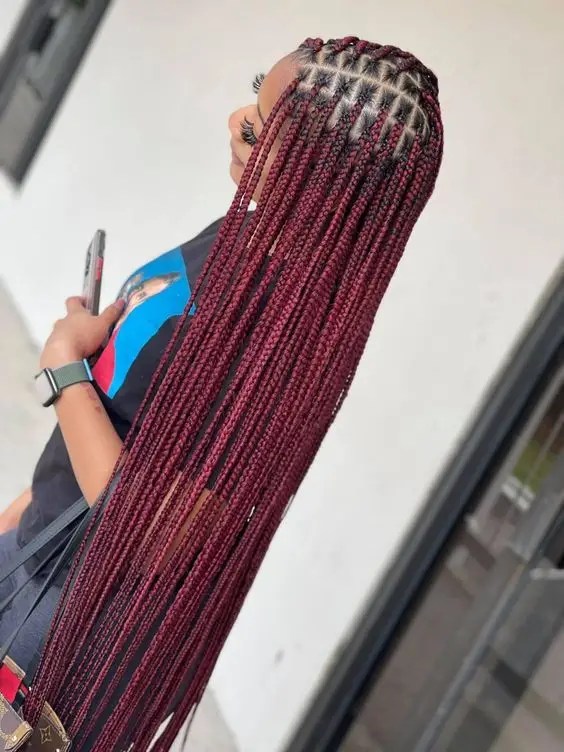 Lady rocks tiny waist-length braids in bright burgundy