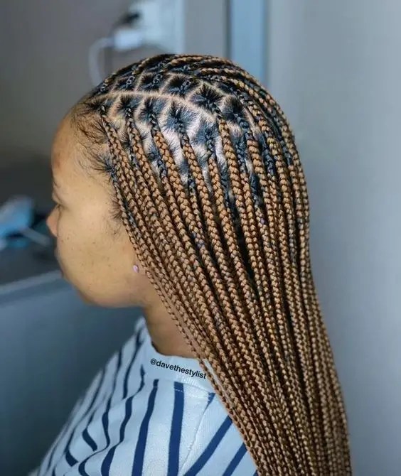 Profile of a woman rocking a small knotless braid