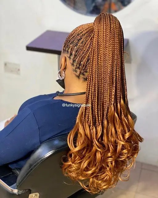 Rear view of a small knotless braid with curls at the ends