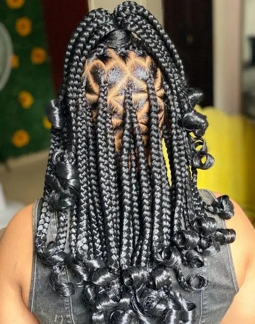 A woman shows off a beautiful love shape braid with curls.