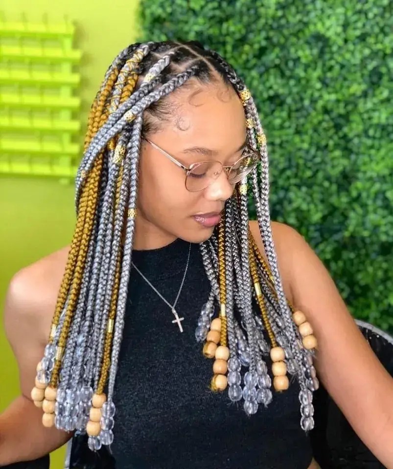 Women lock beautiful multi-colored braids embellished with beads.