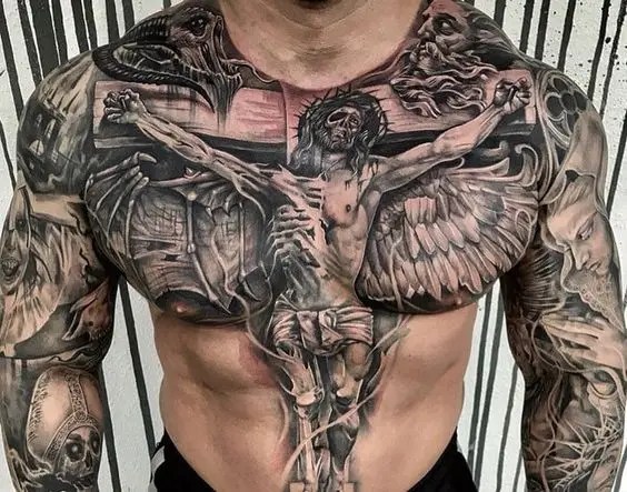 A man shows off a sternum tattoo depicting Jesus on the cross.
