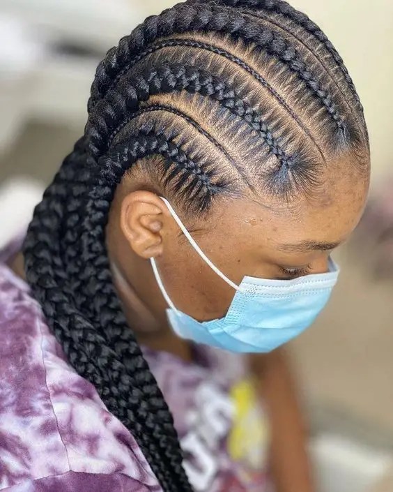 Woman rocking micro-stitched and mini-stitched cornrows while wearing a face mask