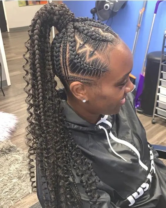 Woman sitting with long curly updo braids rocking