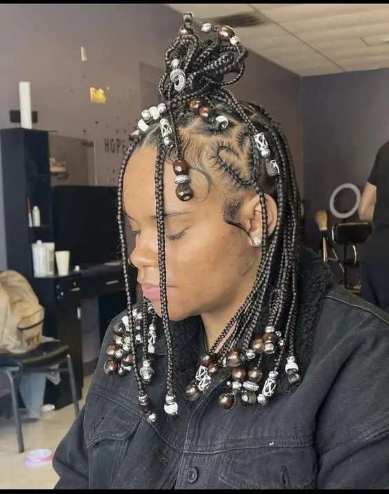 A woman swinging her unknotted beaded braid