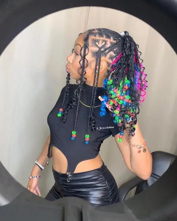 Woman swinging colorful beads in hairstyle