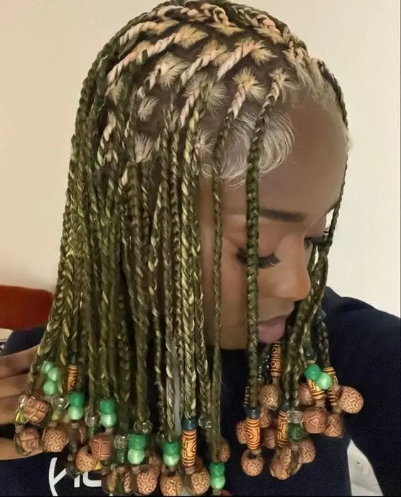 Woman wearing dirty blonde braids with beads