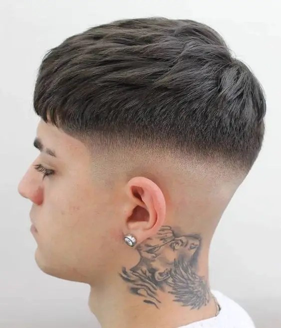 Side view of mid fade haircut and neck tut design