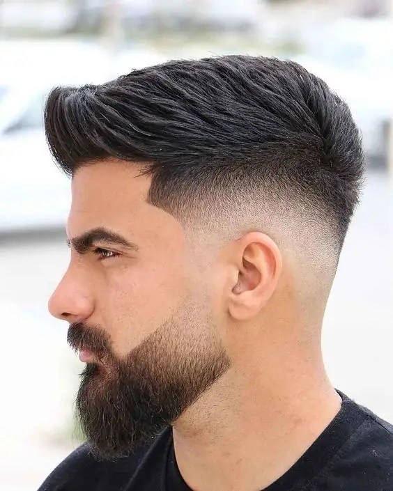 Well-groomed man shows off mid-fade haircut