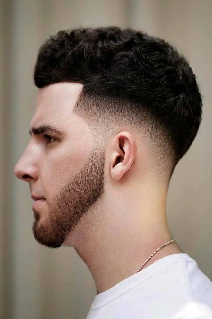 Profile of a man rocking a mid-fade look