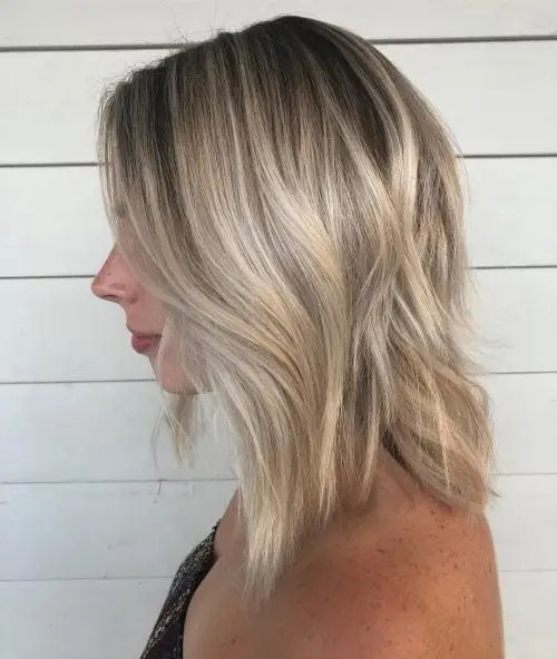 Side profile with icy blonde hair in a bob cut.