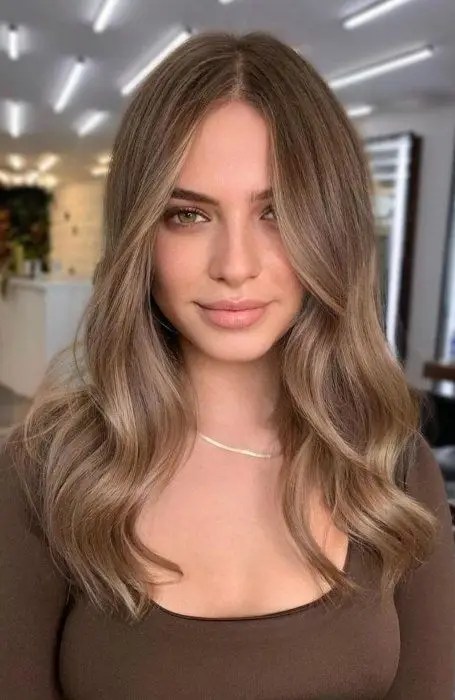 A side parted look of dirty blonde hair.