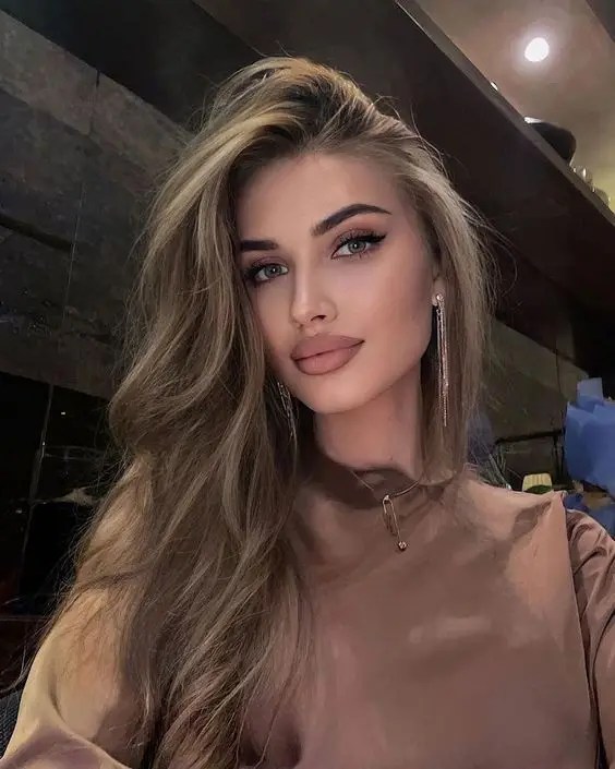 Dirty blond hair as ice in a side part.