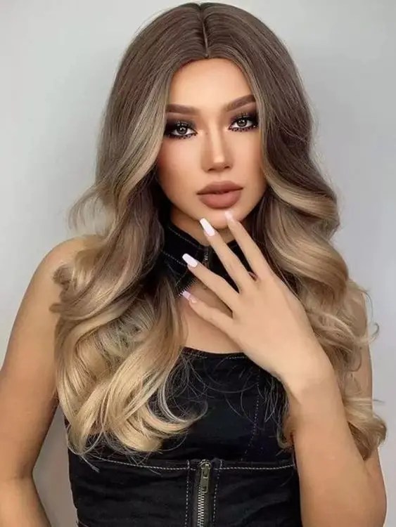 The woman shows off her middle waves with blonde highlights.