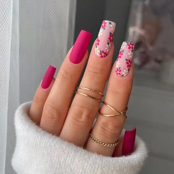 Cute nail design with matte pink polish and light pink floral pattern.