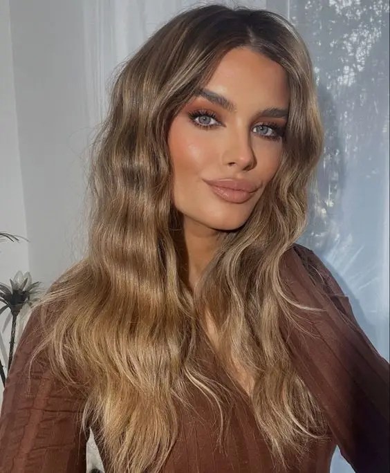 Beautiful lady show with honey colored hair.