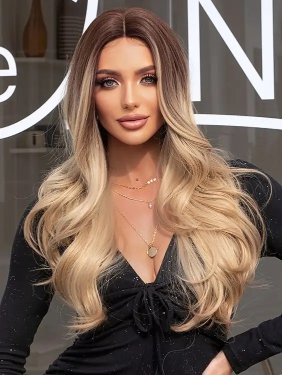 Gorgeous woman rocks wavy hair with dark roots and blonde tips