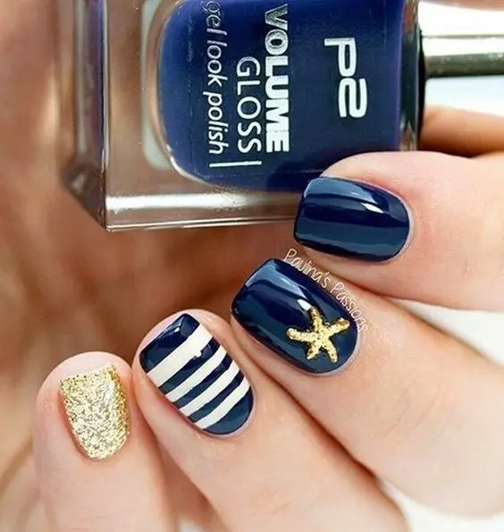 The perfect combination of blue, gold, and white strips is one of the cutest nail designs to rock.