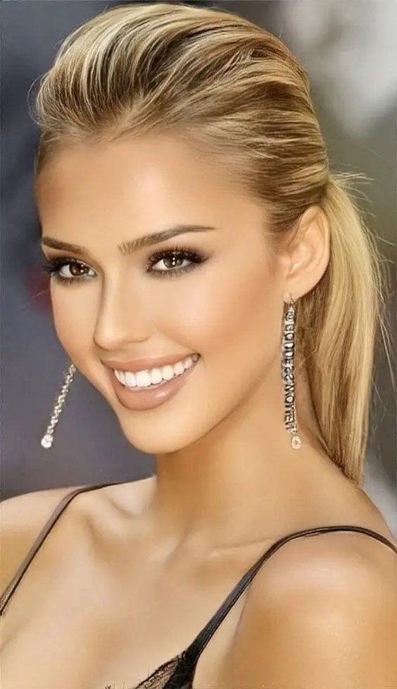 Beautiful woman shows dirty blonde hair gathered in a messy ponytail