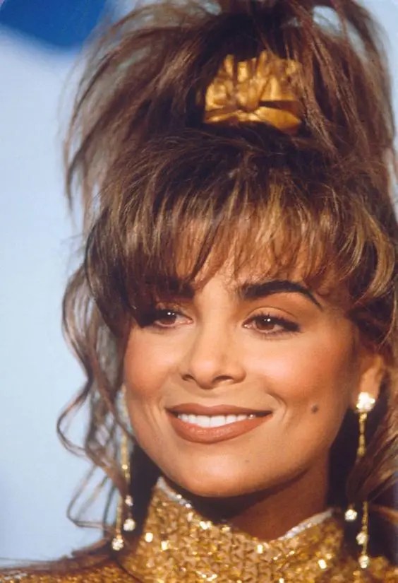 This beautiful 80's hairstyle featured women curling their hair in a messy ponytail
