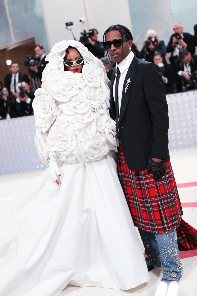 Rihanna wore a white floral gown to pay tribute to the late designer alongside her lover A$AP Rocky.