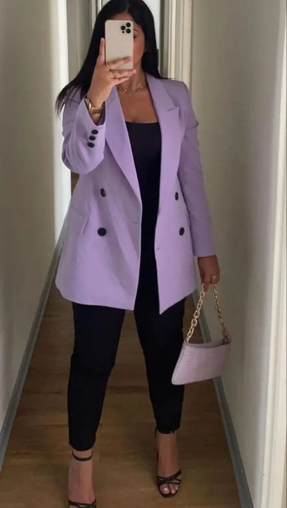 A woman layering her outfit with a light purple blazer