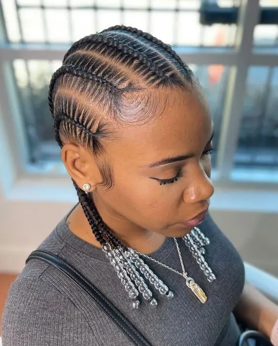 Woman wearing shoulder-length cornrows with beads