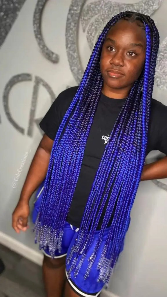 Woman rocking long blue braids decorated with beads