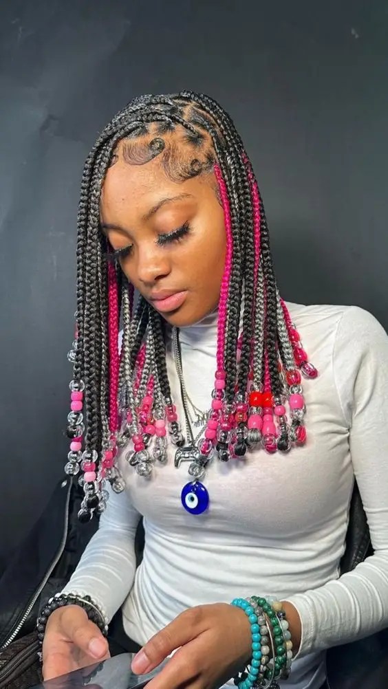 Cute girl swinging black and pink knotless braids with beads