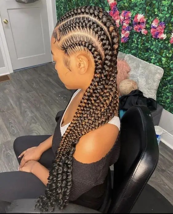 Woman sitting with long curly braids rocking