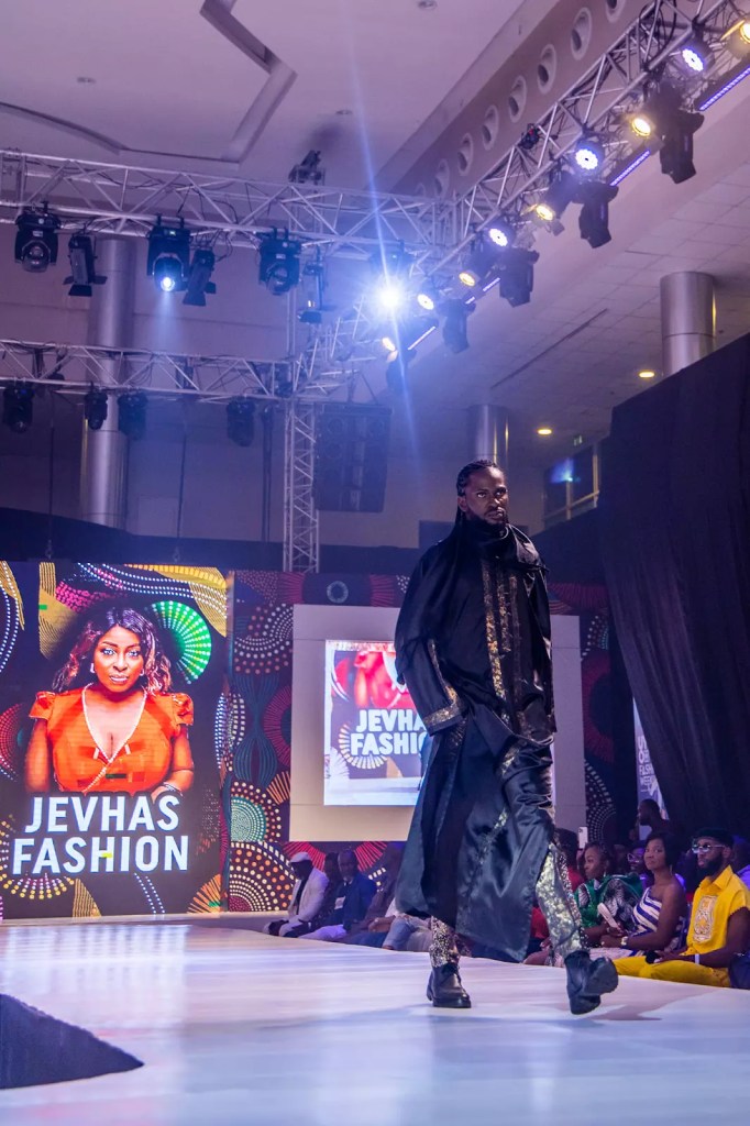 A male model presenting the Ieva collection at a fashion show