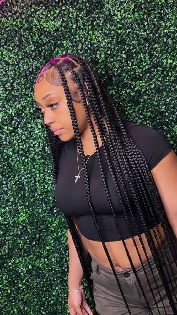 The woman shows off waist-length braids with beautiful curled baby hair.
