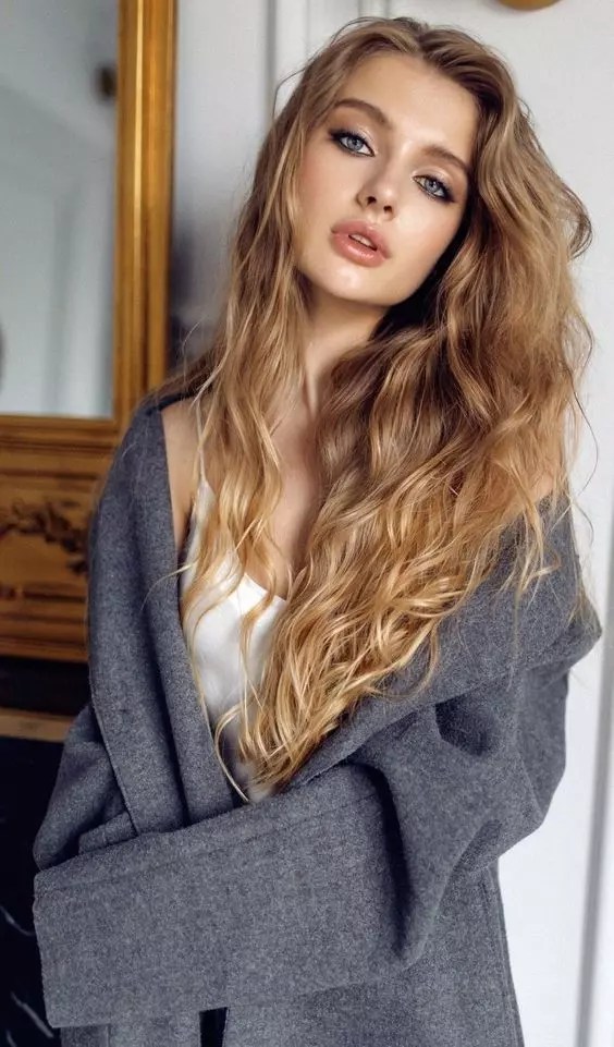 Beautiful woman with long gorgeous messy blond hair.
