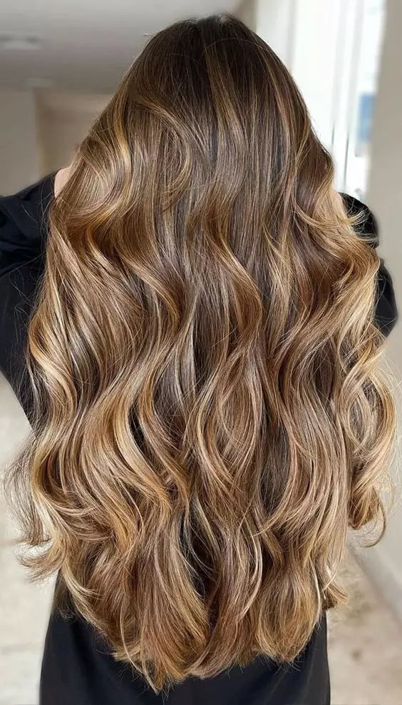 Back view with long wavy gorgeous blonde hair.