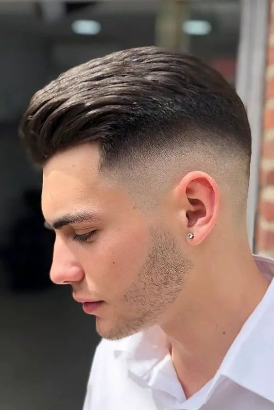 Side view of manicured mid fade cut
