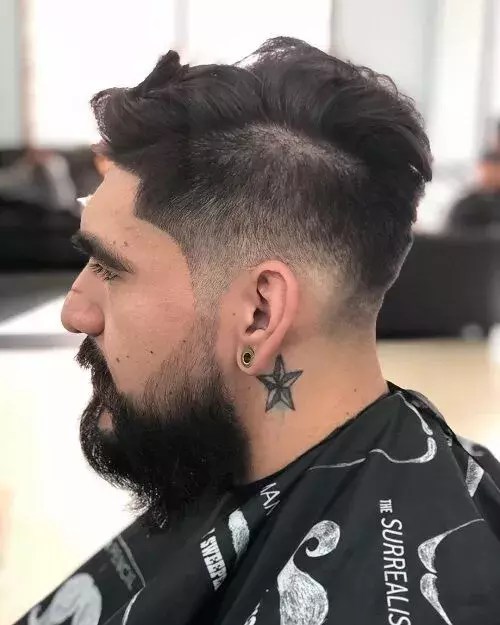 Profile of a man rocking a mid-drop look