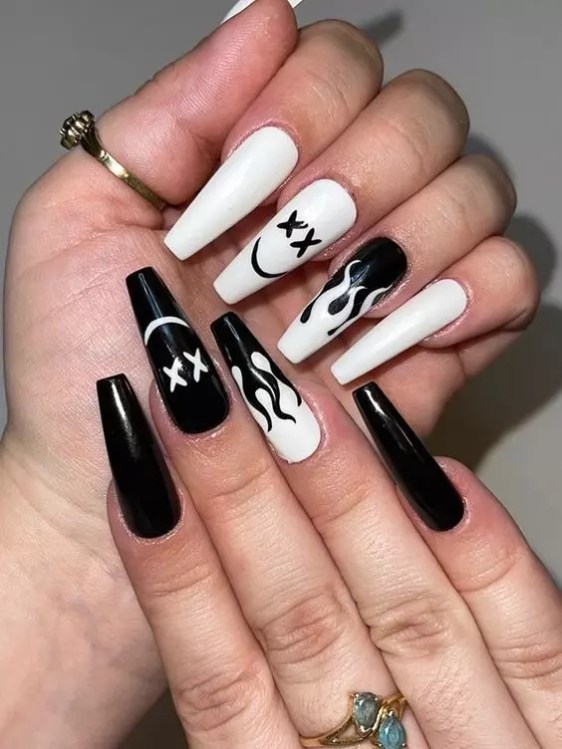 Black and white manicure with funny toon pictures is the best cute nail design that will attract attention.