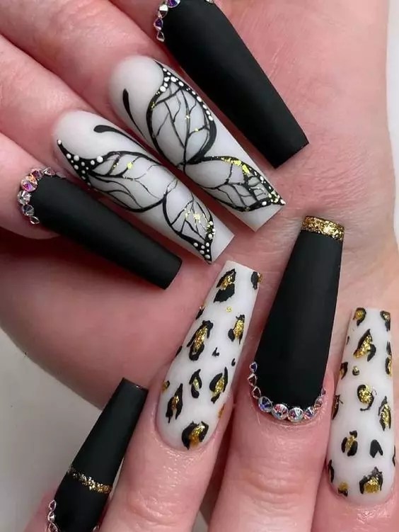 A cute nail design with sparkling accessories and gold polka dots.