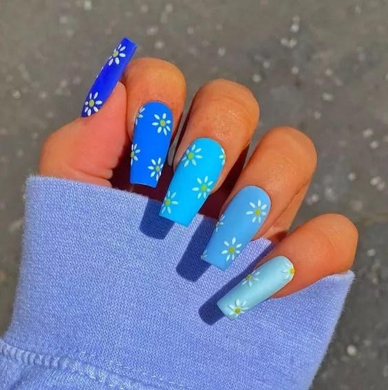 Deep blue and sky blue nail polishes and some floral prints are the cutest nail designs you'll want to try.