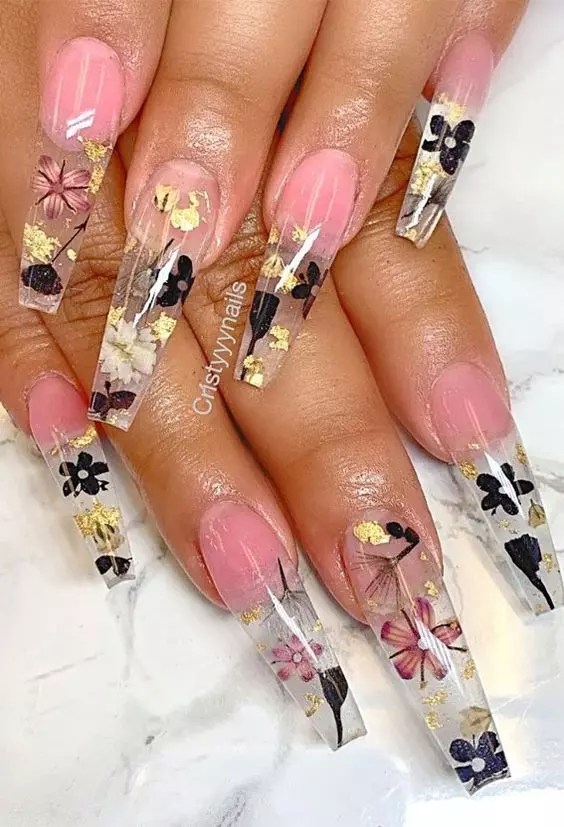 A cute nail design with beautiful pressed nails and a flower print.