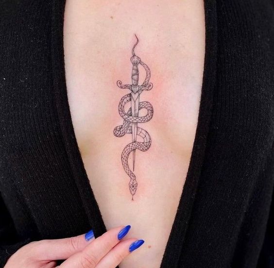 Woman shows off sternum tattoo design with snake motif