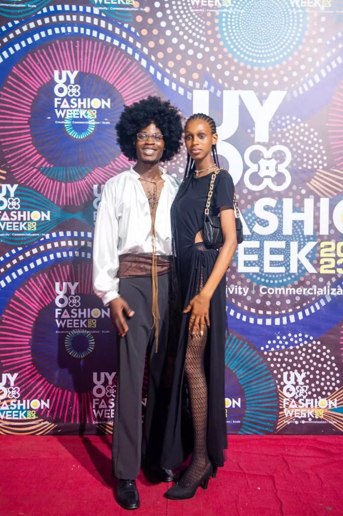 A man and a woman showing off their arte style on the red carpet.