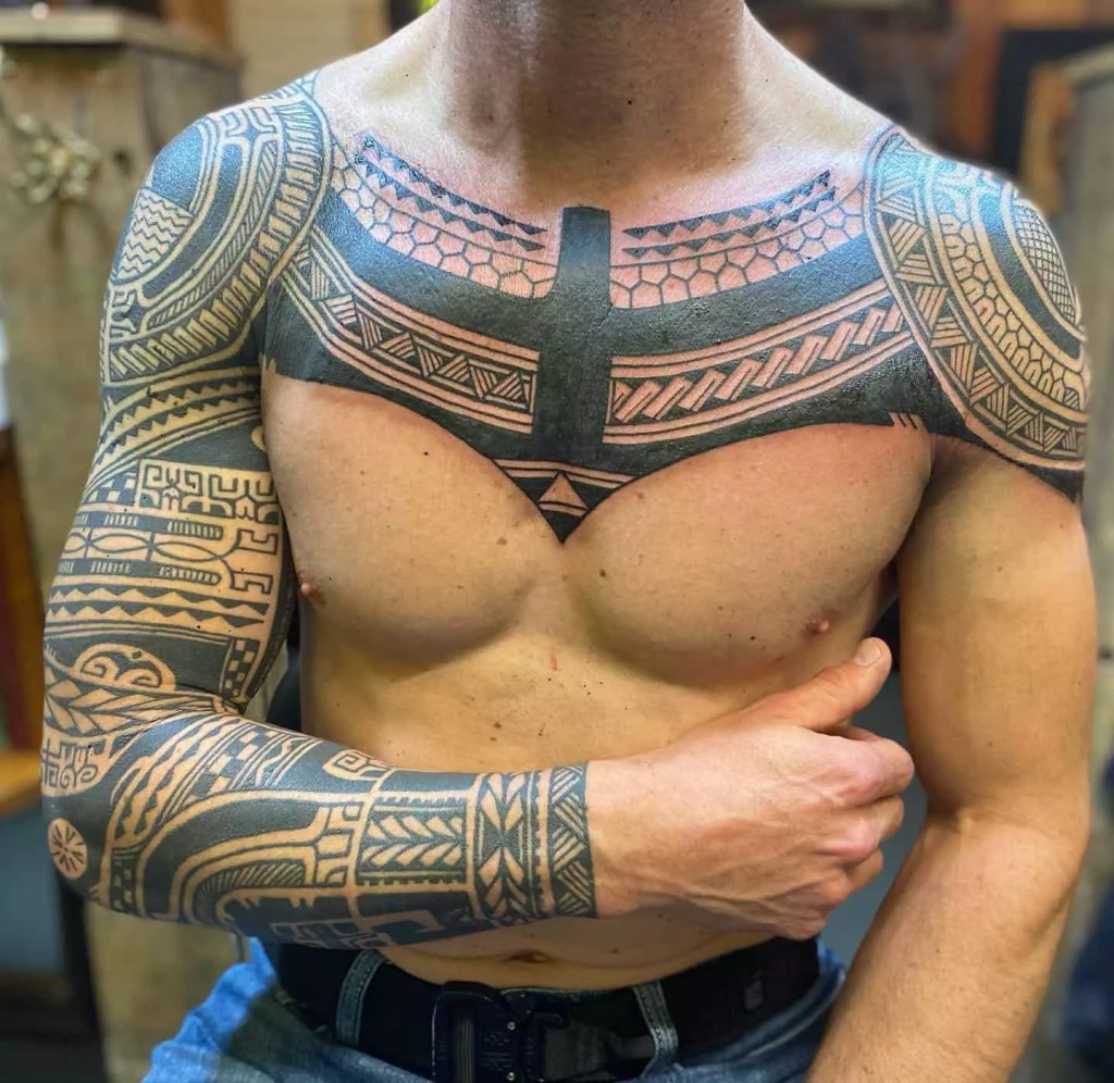 Man rocks beautiful tribal sternum tattoo.