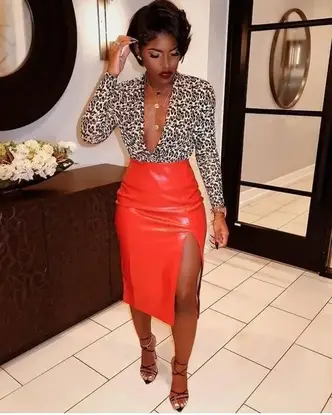 lady wearing animal print top on leather pencil skirt