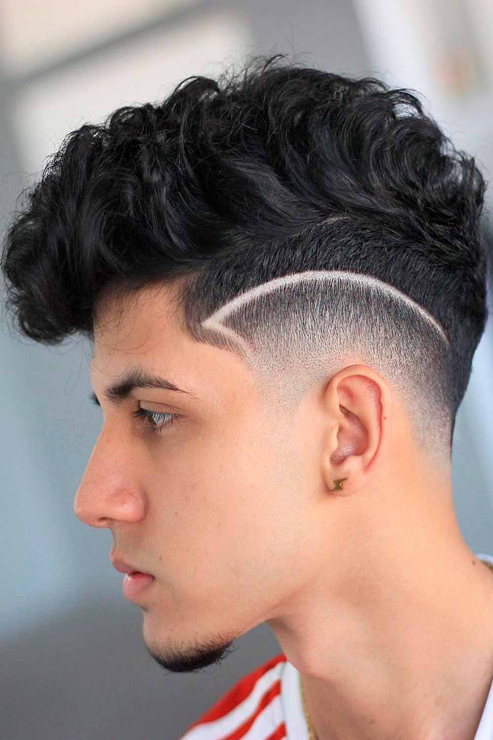 man wearing pompadour curly hair with fade