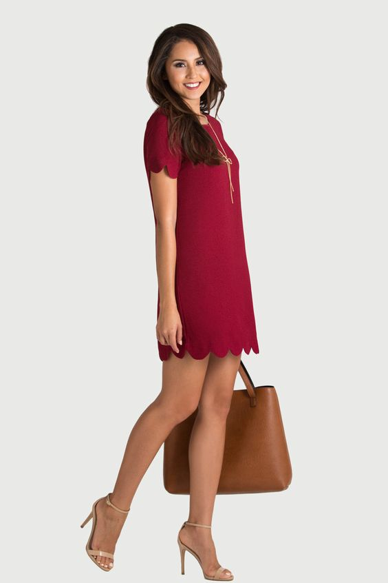 Woman wearing burgundy shift dress with zipper in front