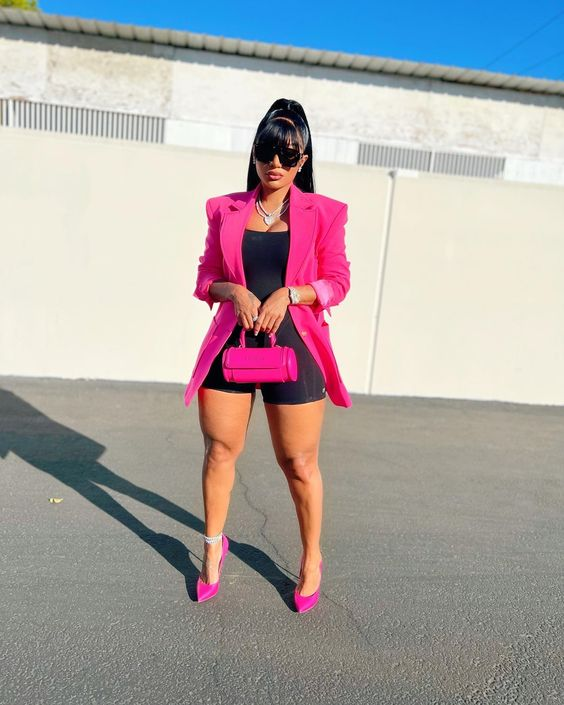 Woman wearing a pink suit that matches bad shoes